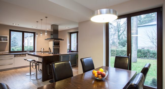 Travertine house - view of a dining room and kitchen